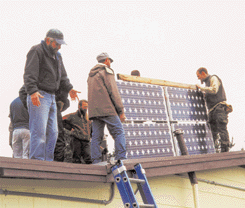 Putting the panels on the roof.